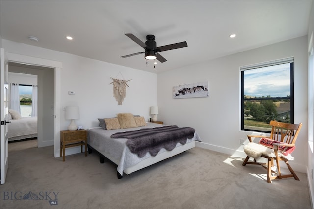 bedroom with ceiling fan and light carpet