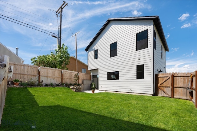 back of house with a lawn