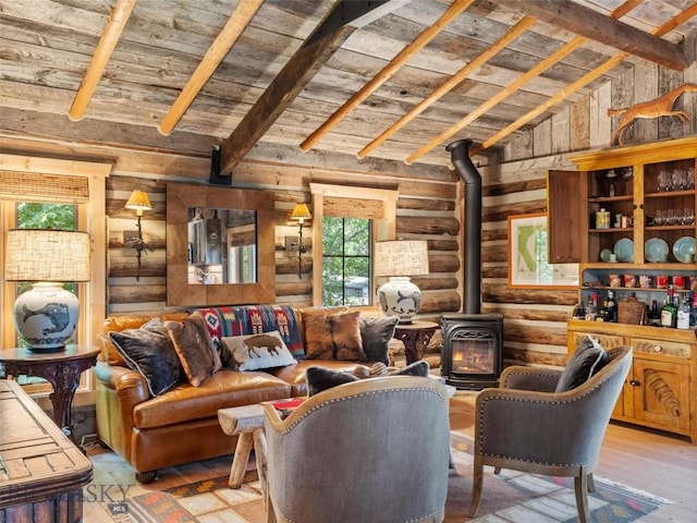 living area with a wood stove, wood ceiling, light wood-style flooring, and beamed ceiling