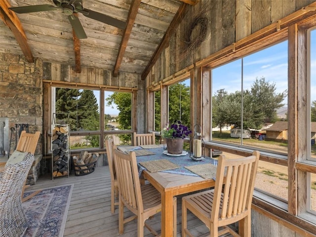 sunroom featuring wooden ceiling, ceiling fan, and lofted ceiling with beams