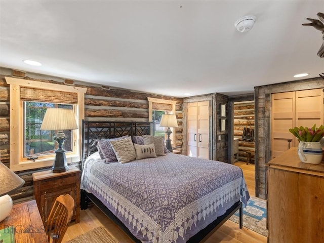 bedroom featuring recessed lighting, rustic walls, and hardwood / wood-style floors