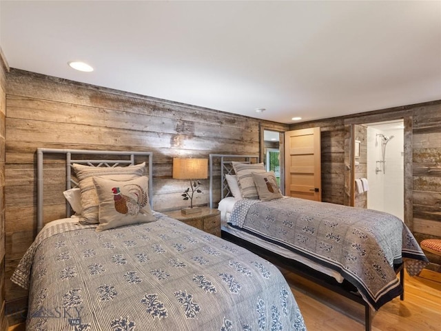 bedroom with wood walls, wood finished floors, and recessed lighting