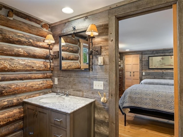 bathroom with recessed lighting, vanity, and wood finished floors