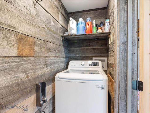 laundry room featuring washer / dryer and wooden walls