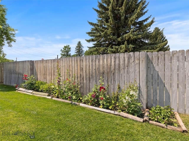 view of yard featuring a garden and a fenced backyard