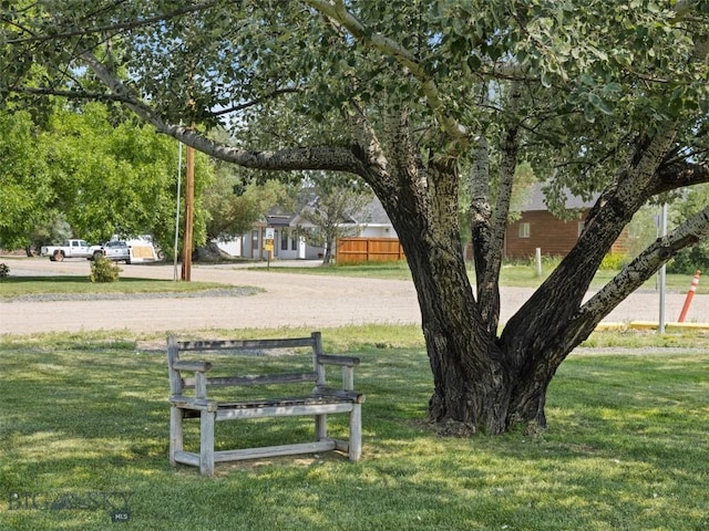 surrounding community featuring a yard and fence