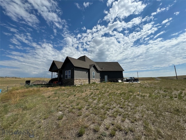 view of front of house with a rural view