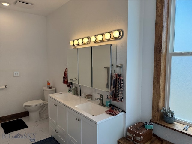 bathroom featuring vanity and toilet