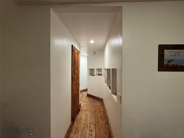 3 Sage Trl, Big Timber, MT 59011 - corridor featuring a textured wall, an upstairs landing, and wood finished floors