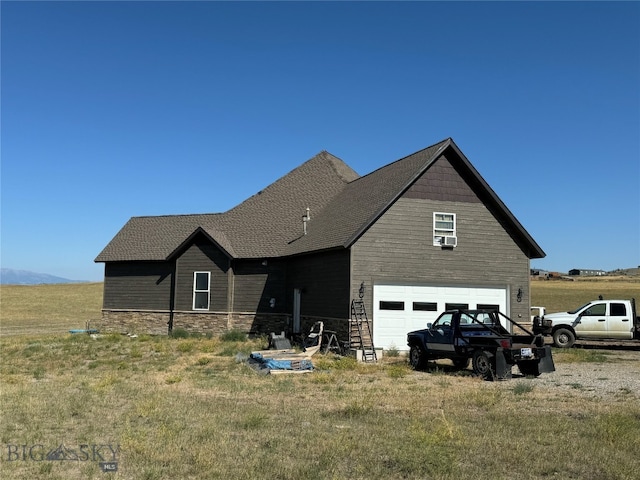 back of property with a garage