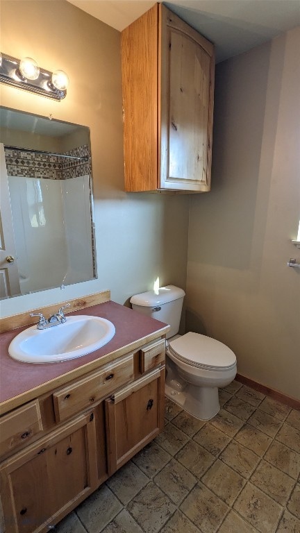 bathroom featuring tile patterned floors, a shower, toilet, and vanity