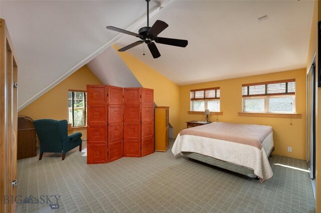 carpeted bedroom featuring ceiling fan, lofted ceiling, and multiple windows