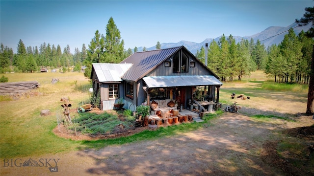 view of front facade featuring a mountain view and a rural view