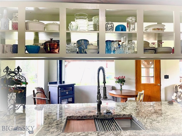 kitchen with sink and a wood stove