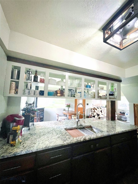 bar with a textured ceiling and sink