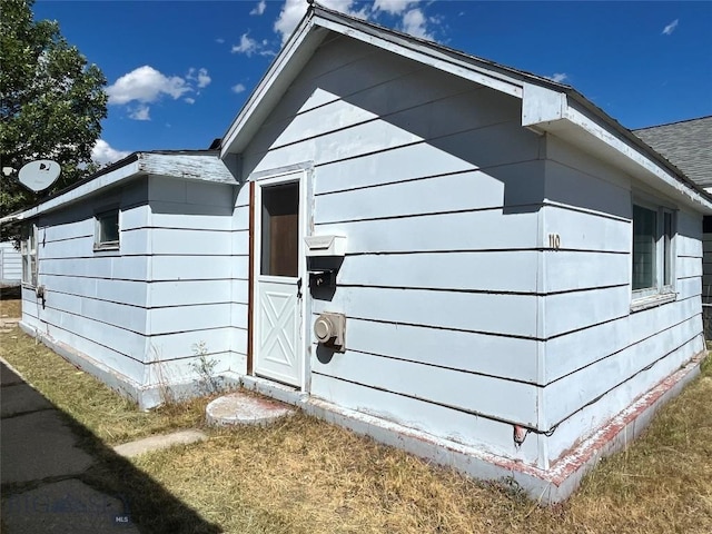 view of side of property with a yard