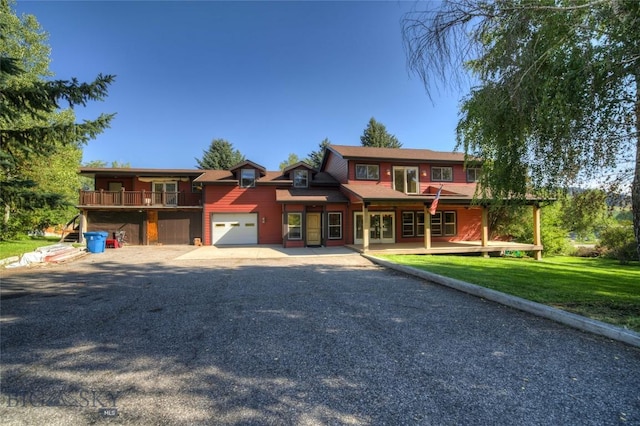 8733 Huffman, Bozeman, MT 59715 - view of front of property featuring a front lawn, driveway, a garage, and french doors