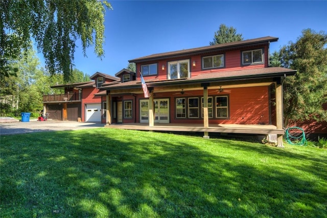 8733 Huffman, Bozeman, MT 59715 - view of front of home with a front yard, a ceiling fan, an attached garage, and driveway