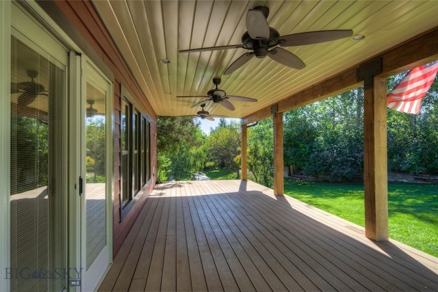 8733 Huffman, Bozeman, MT 59715 - wooden terrace featuring a ceiling fan and a lawn