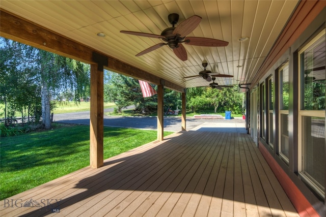 wooden terrace with a yard and ceiling fan