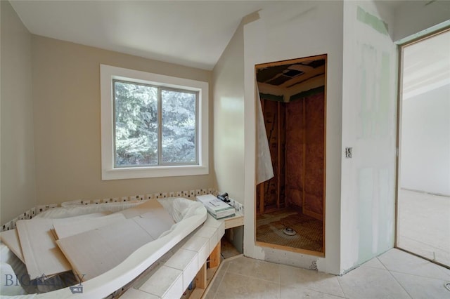 8733 Huffman, Bozeman, MT 59715 - full bath with a garden tub, a stall shower, lofted ceiling, and tile patterned floors