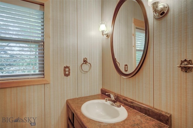 8733 Huffman, Bozeman, MT 59715 - bathroom with wallpapered walls, a wealth of natural light, and vanity