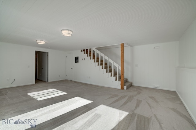 basement featuring light colored carpet