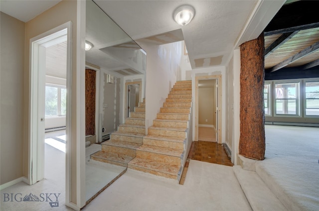 staircase with carpet flooring and a baseboard radiator