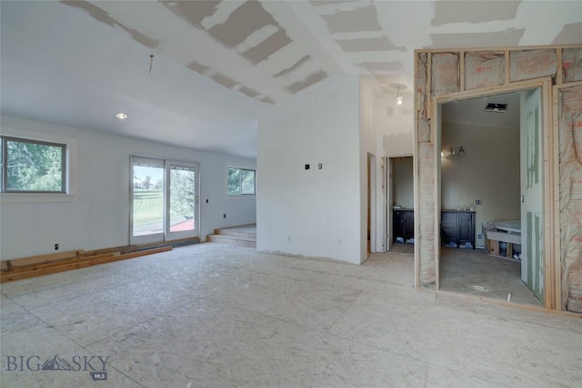 8733 Huffman, Bozeman, MT 59715 - spare room featuring vaulted ceiling