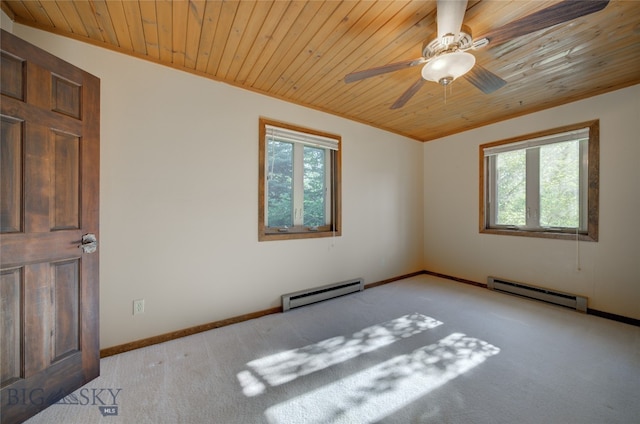 carpeted spare room with a baseboard heating unit, ceiling fan, and a wealth of natural light