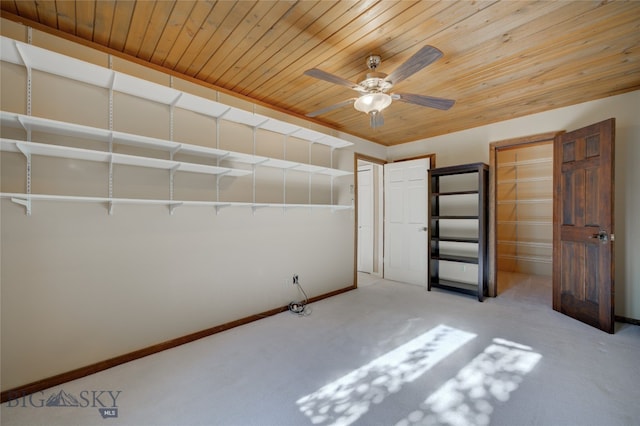 unfurnished bedroom featuring ceiling fan, light colored carpet, and wooden ceiling