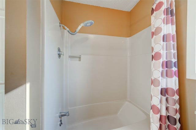 bathroom featuring shower / tub combo with curtain and a textured ceiling