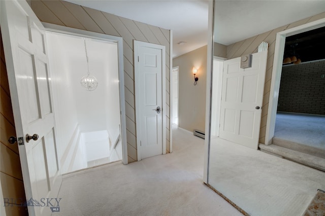 bathroom featuring a baseboard heating unit and a notable chandelier