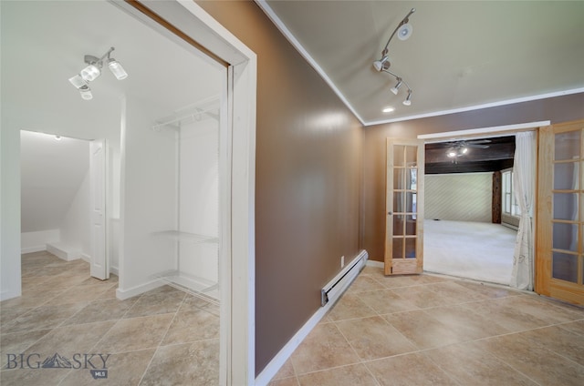 hall featuring crown molding, a baseboard radiator, and rail lighting