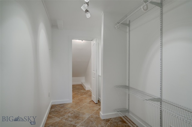 walk in closet featuring light tile patterned flooring