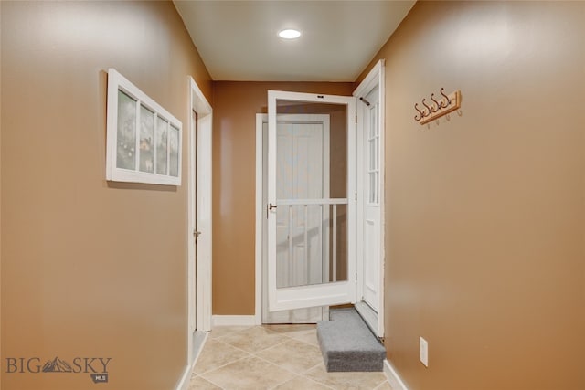 hallway featuring light tile patterned floors