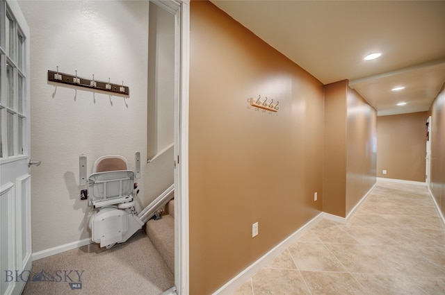 hall featuring light tile patterned floors