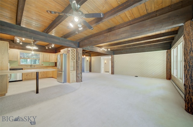 interior space with baseboard heating, light carpet, stainless steel refrigerator, sink, and ceiling fan