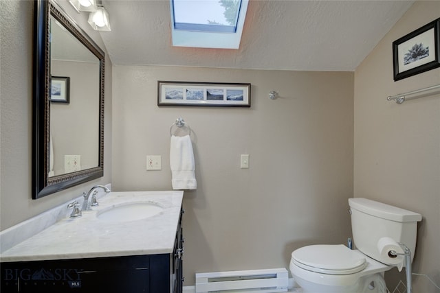 bathroom with toilet, lofted ceiling with skylight, vanity, a textured ceiling, and a baseboard heating unit