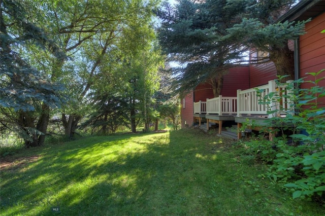 8733 Huffman, Bozeman, MT 59715 - view of yard featuring a wooden deck