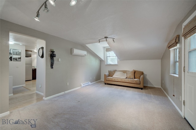 unfurnished room featuring track lighting, vaulted ceiling, light carpet, and a wall mounted air conditioner