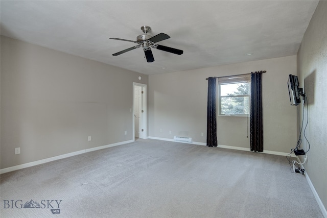 carpeted spare room with ceiling fan