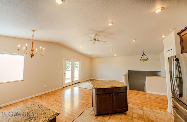 25 Amber, Dillon, MT 59725 - kitchen featuring freestanding refrigerator, ceiling fan, a chandelier, lofted ceiling, and open floor plan