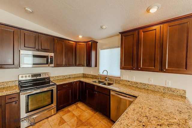 25 Amber, Dillon, MT 59725 - kitchen featuring stainless steel appliances, a sink, lofted ceiling, light stone counters, and recessed lighting