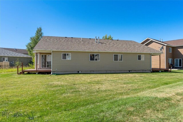 rear view of house with a yard