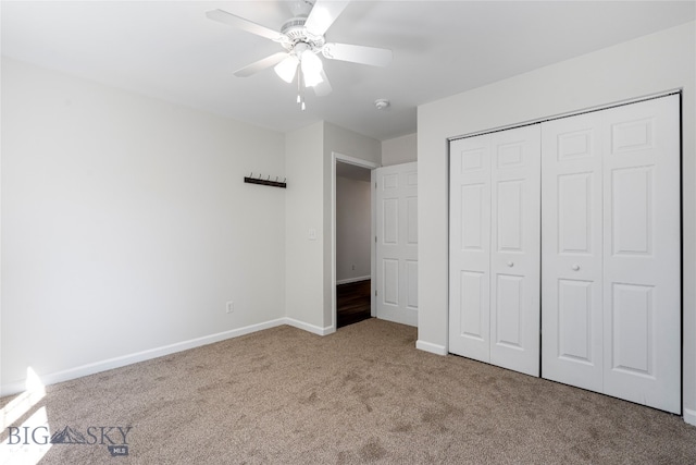 unfurnished bedroom featuring carpet flooring, ceiling fan, and a closet