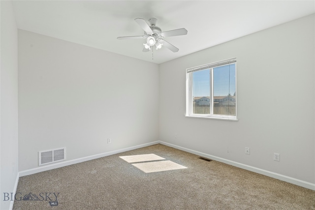 empty room featuring ceiling fan and light carpet