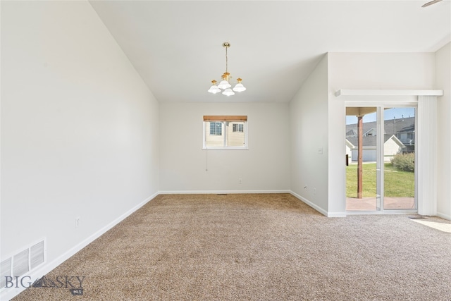 carpeted empty room with a wealth of natural light and a notable chandelier