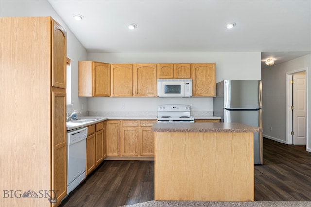 kitchen with dark wood-type flooring, white appliances, light brown cabinetry, and a kitchen island