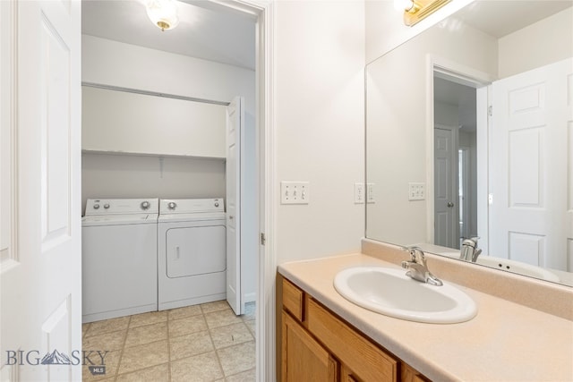 bathroom featuring washer and dryer and vanity